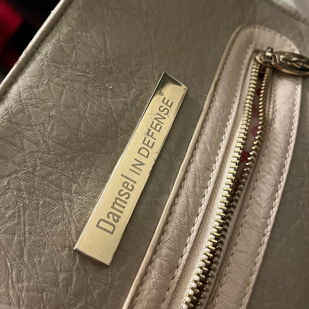 Beige Damsel in Defense purse. Made for concealed carry weapons for women
